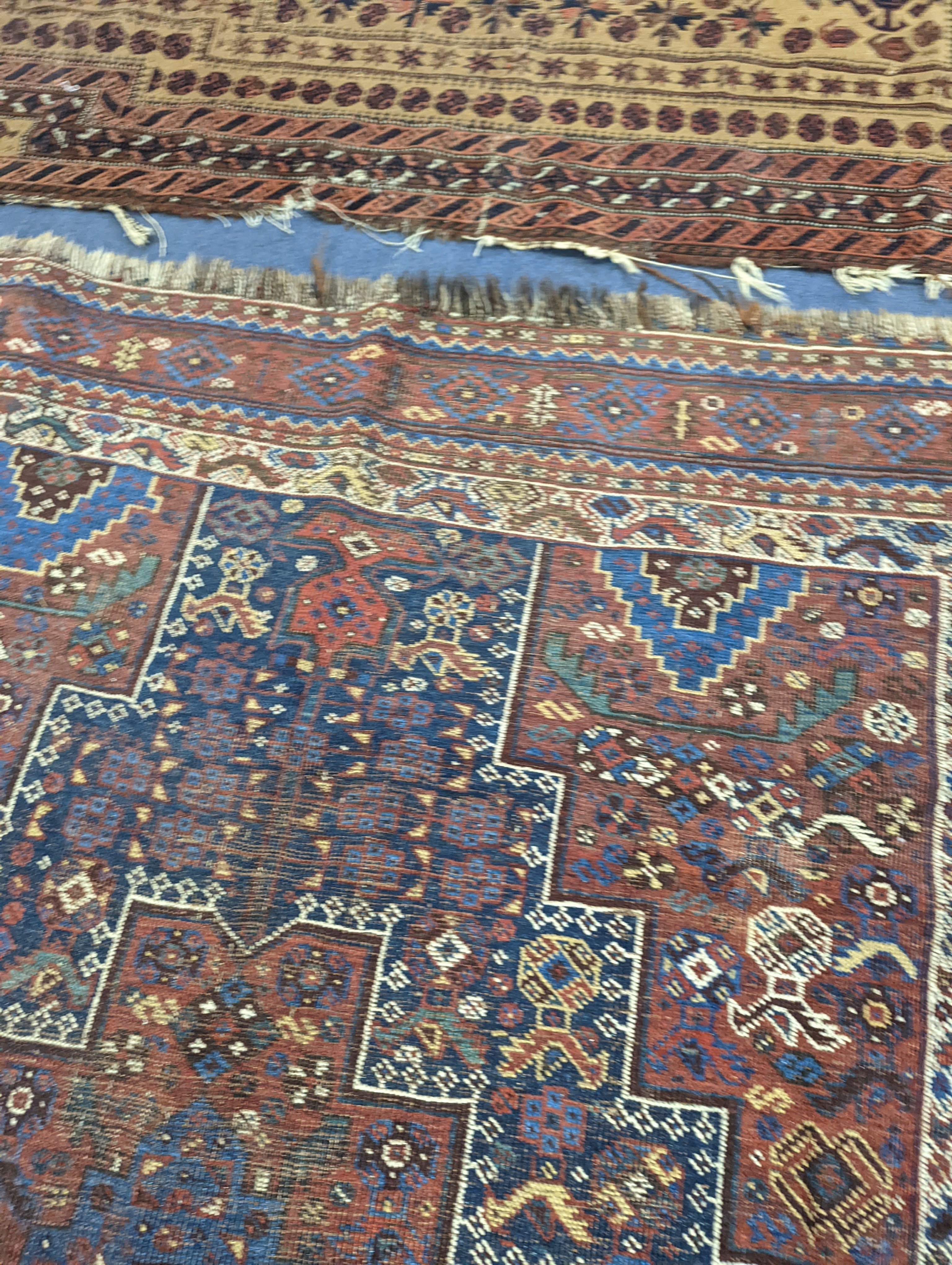 A Caucasian red ground rug and a Belouch rug, larger 200 x 165cm